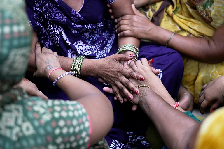 Air India plane crash victim's relative is comforted as she breaks down at a hospital in Ahmedabad - Rafiq Maqbool/ AP