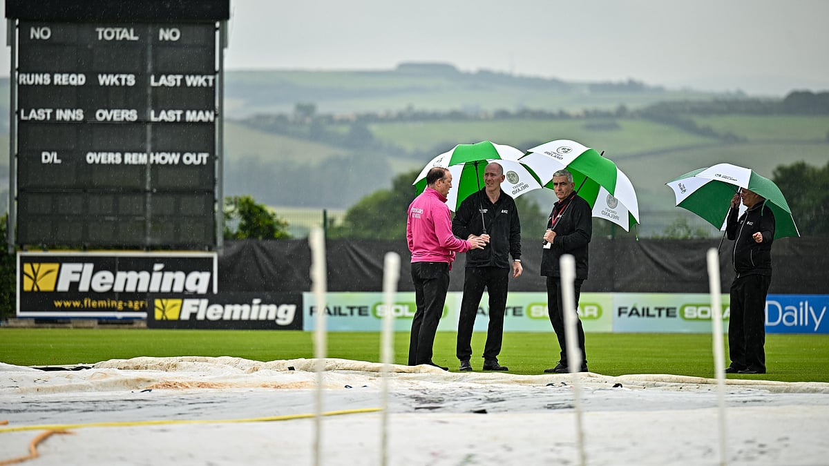 Photo: X/Cricket Ireland : Umpires and match officials inspect the ground amid rain in Bready, the venue for the second Ireland vs West Indies T20I.