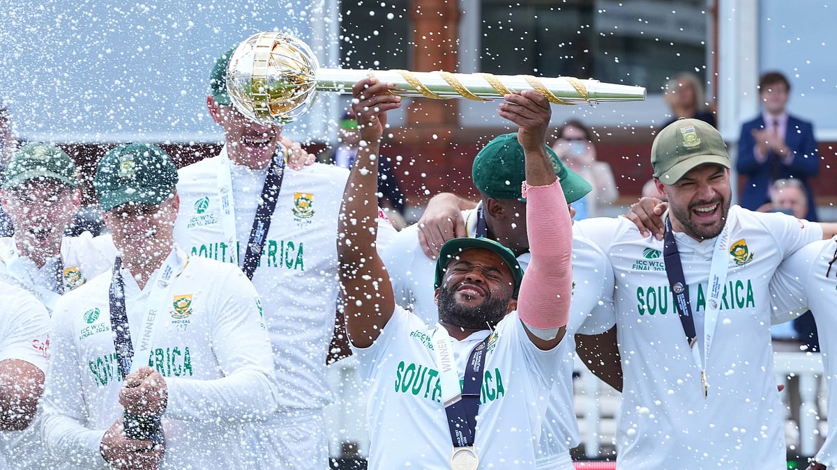 South Africa's captain Temba Bavuma holds the winner's trophy and celebrates with teammates after their win in the World Test Championship final against Australia at Lord's cricket ground in London, Saturday, June 14, 2025. 

 - (AP Photo/Kirsty Wigglesworth)
