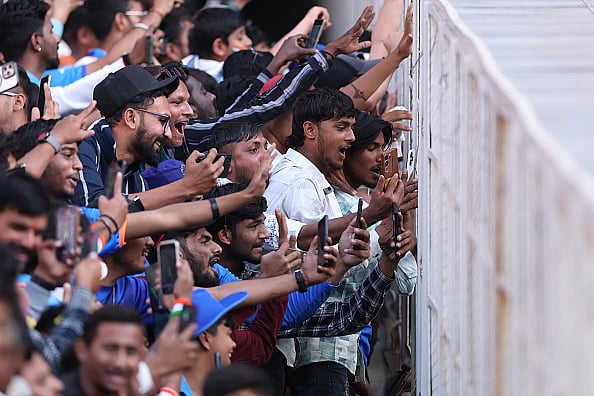 Photo by Michael Steele/Getty Images : AHMEDABAD, INDIA - FEBRUARY 12: India supporters try to get the attention of the England players next to the tunnel during the 3rd ODI match between India and England at Narendra Modi Stadium on February 12, 2025 in Ahmedabad, India.