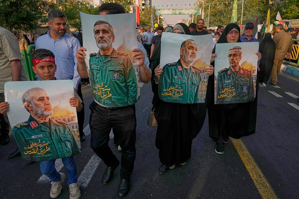 AP Photo/Vahid Salemi : Demonstrators carry posters of top Iranian commanders killed in Friday's Israeli strikes on Tehran, during the Muslim Shiite holiday of Eid al-Ghadir, which commemorates the Prophet Muhammad naming Ali, revered as the first Shiite imam, as his successor, in Tehran, Iran, Saturday, June 14, 2025. 