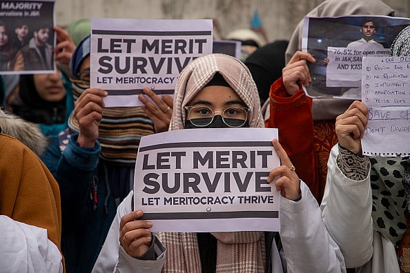 Photo by Faisal Bashir/SOPA Images/LightRocket via Getty Images : Kashmiri medical students hold placards as they take part in a protest led by the ruling National Conference leader and member of Indian Parliament Aga Syed Ruhullah Mehdi outside the chief minister's official residence in Srinagar's Gupkar Road demanding fairness and rationality in Jammu and Kashmir's reservation policy. The protest was joined by students from the open merit category and leaders of other political parties. The reservation policy introduced by the Lieutenant Governor led administration before the region's assembly elections earlier this year, increased quotas for reserved categories to 60% while reducing the general category to 40%. This has drawn widespread criticism with many labelling it discriminatory against the general population. 