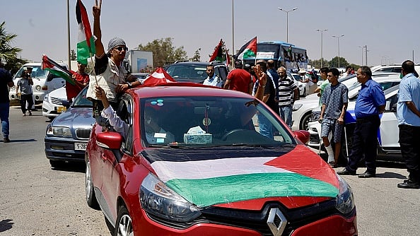 Hazem Turkia/Anadolu via Getty Images : A massive land convoy of activists, humanitarian volunteers, and civil society leaders making their way from Tunisia toward the Gaza Strip.