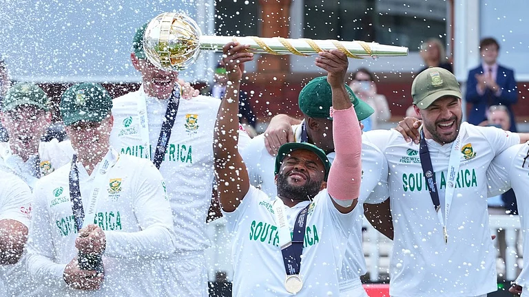 South Africa captain Temba Bavuma holds the winner's trophy and celebrates with teammates after their win in the ICC World Test Championship 2025 final against Australia at Lord's. - AP