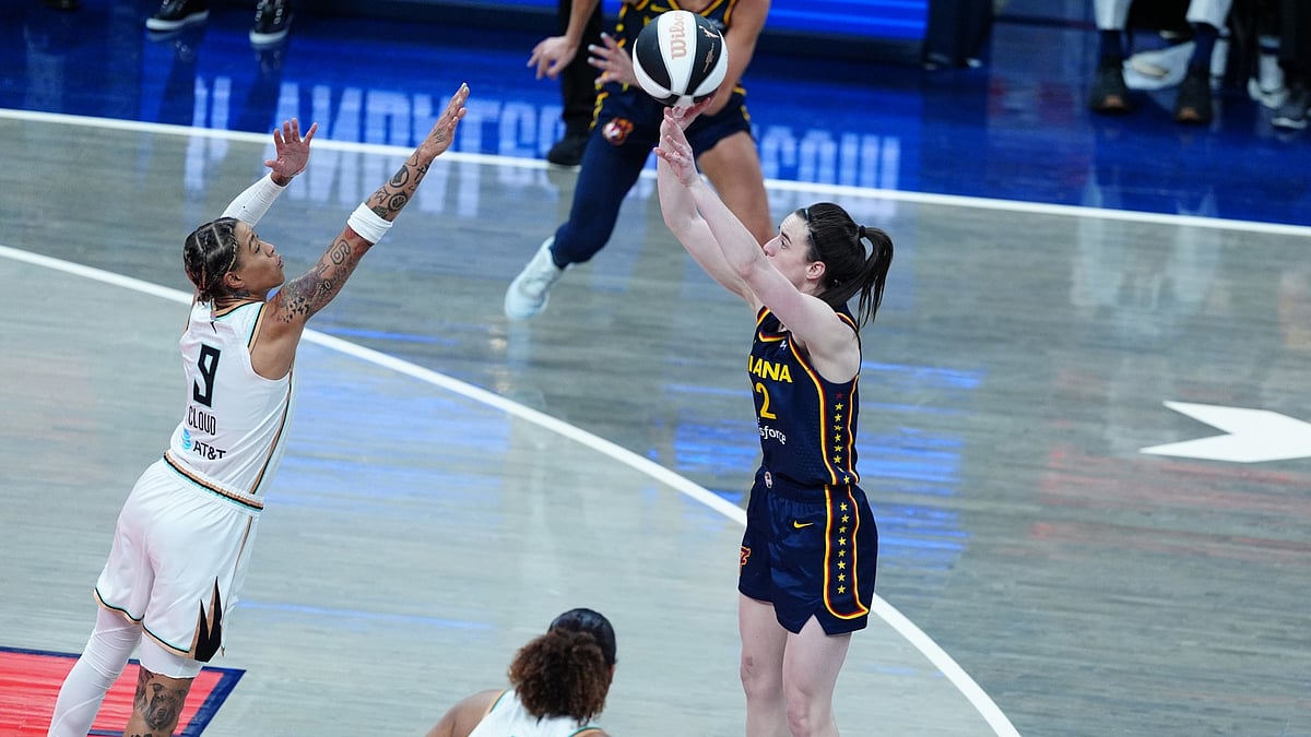 Indiana Fever guard Caitlin Clark (22) takes a shot against New York Liberty guard Natasha Cloud (9) on June 14, 2025, at Gainbridge Fieldhouse in Indianapolis, Indiana. - null