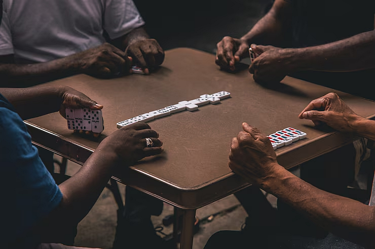 A group of hands on a gaming table