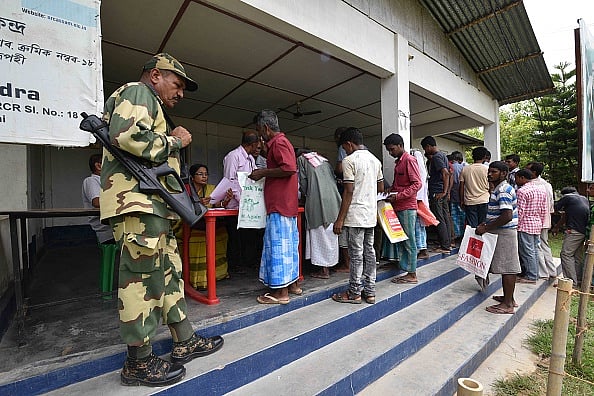 Anuwar Hazarika/NurPhoto via Getty Images : People wait in line to check their names on the draft list at the National Register of Citizens (NRC) 