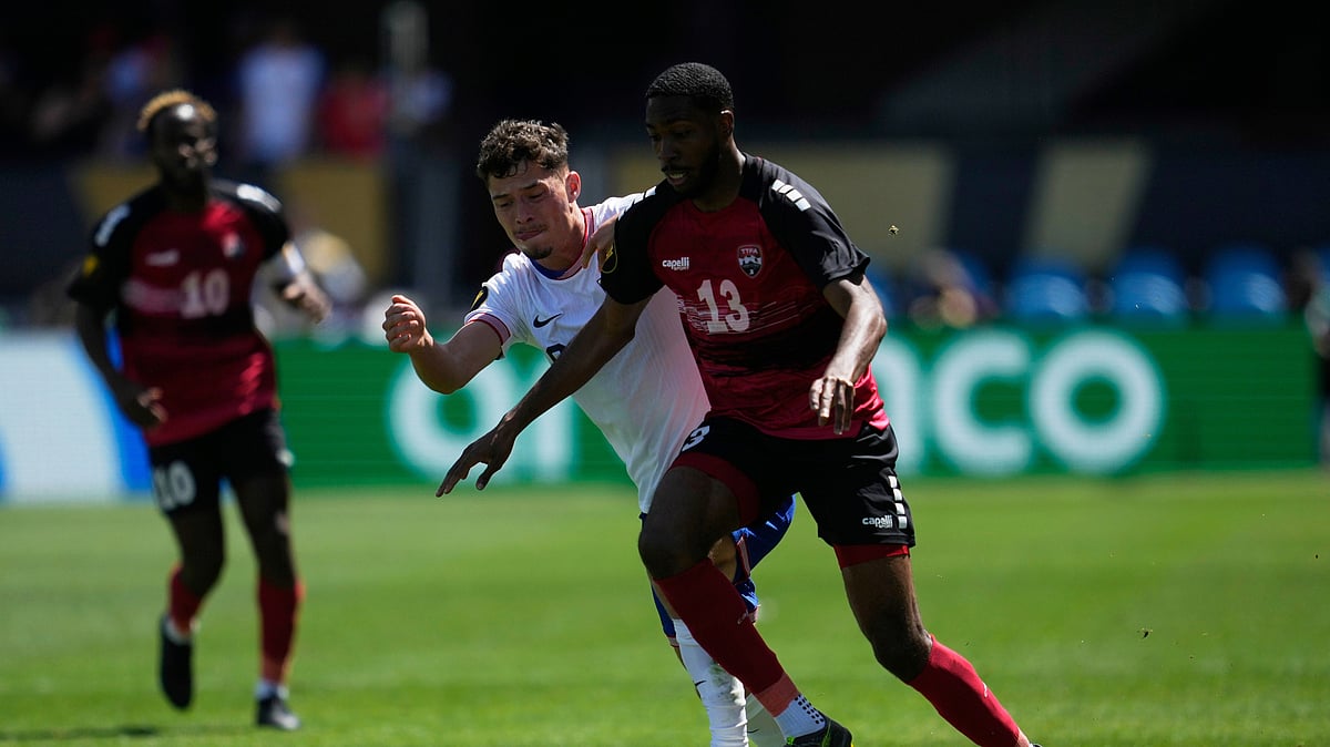 AP Photo/Jeff Chiu : Trinidad and Tobago midfielder Tyrese Spicer (13) runs toward the ball against United States midfielder Sebastian Berhalter, front left, during the first half of a CONCACAF Gold Cup football match in San Jose, California.