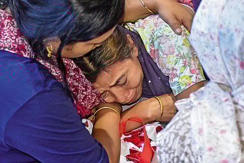 Mala, the mother of the twenty-one-year-old cabin crew member Kongbrailatpam Nganthoi, who lost her life, being consoled by family members