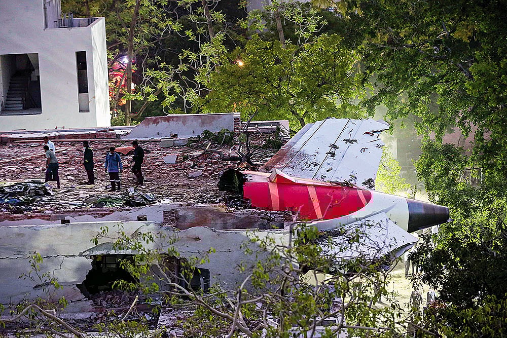 | Photo: PTI : Mangled Remains: The tail end of the crashed Air India flight. The plane first fell on the canteen for medical students