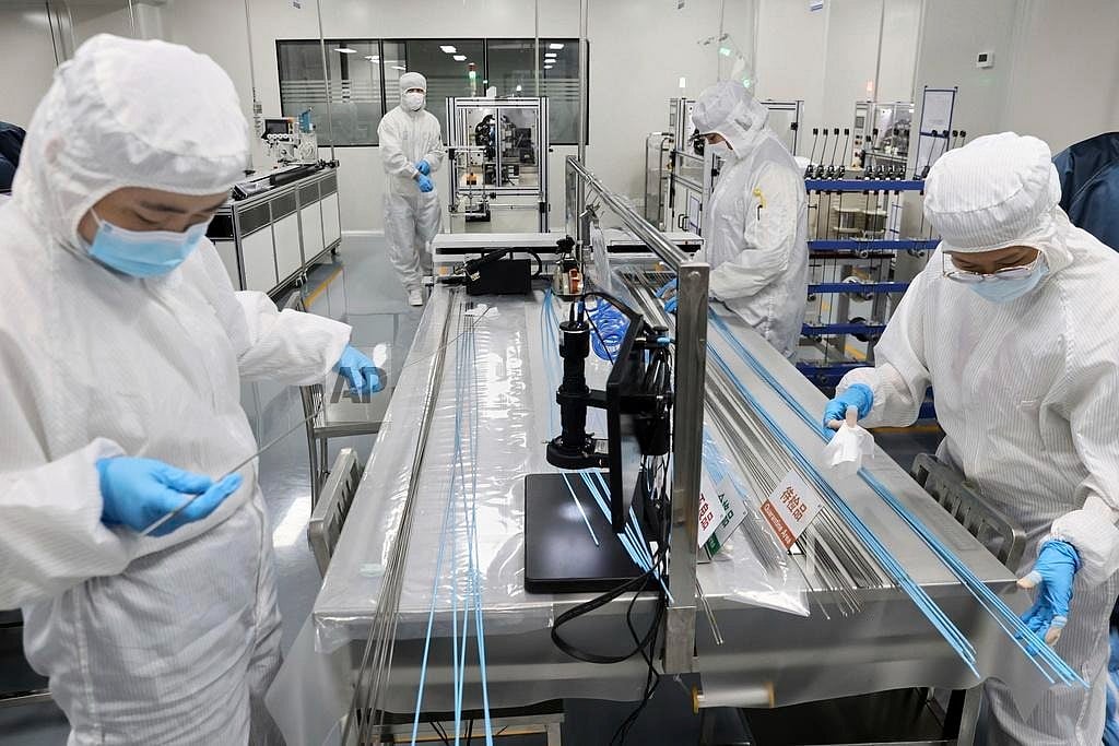 Chinatopix via AP : Workers labor at a manufacturer of medical polymer precision catheters, in Nantong city in east China's Jiangsu province on April 24, 2025.