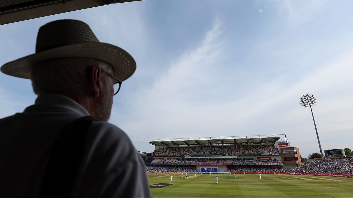 (AP Photo/Scott Heppell) : A fan watches the play on day one of the first cricket test match between England and India at Headingley in Leeds, England, Friday, June 20, 2025, 