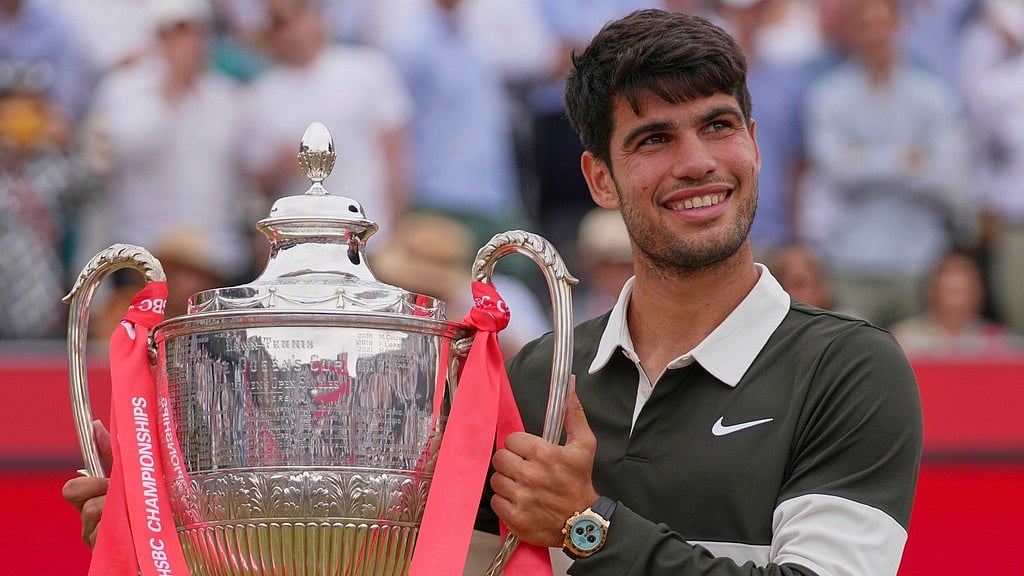 AP : Carlos Alcaraz holds up the winner's trophy after defeating Jiri Lehecka in the men's singles final of the Queen's Club.