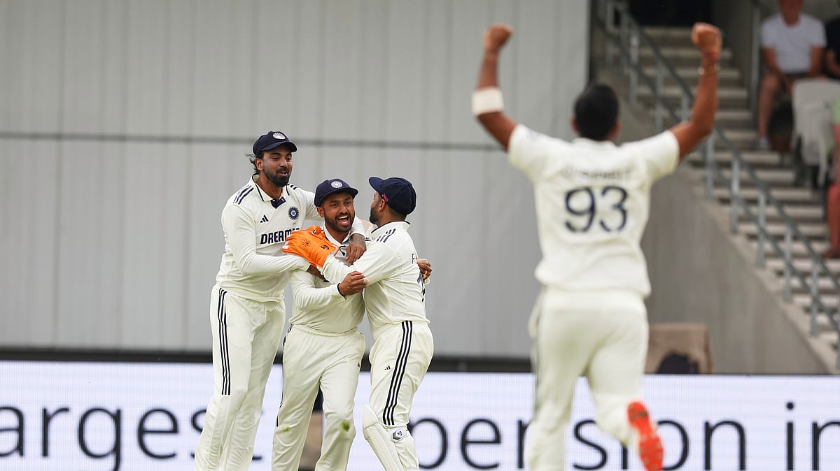 Indias Jasprit Bumrah, right, and teammates celebrate the dismissal. AP