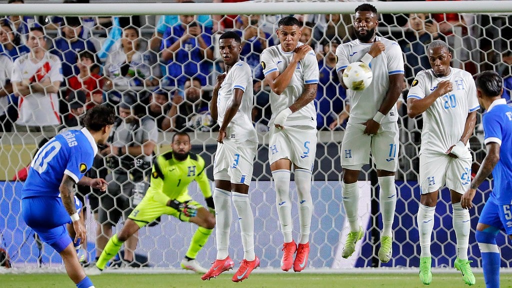 AP/Michael Wyke : El Salvador's Enrico Duenas, left, launches a penalty kick into Honduras' defenders Jose Martinez (3), Kervin Arriago (5), Jorge Benguche (11) and Deybi Flores (20) during a CONCACAF Gold Cup soccer.