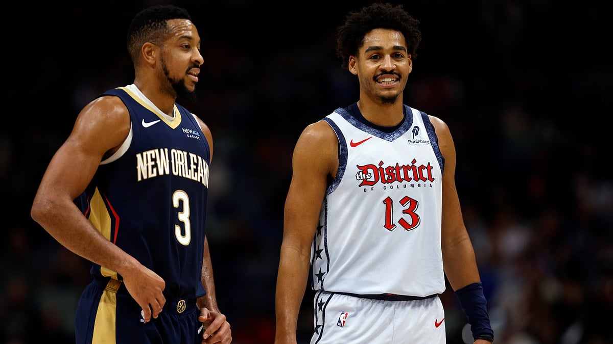 CJ McCollum #3 of the New Orleans Pelicans stands on the court with Jordan Poole #13 of the Washington Wizards during the third quarter of an NBA game at Smoothie King Center on January 03, 2025 in New Orleans, Louisiana. - null