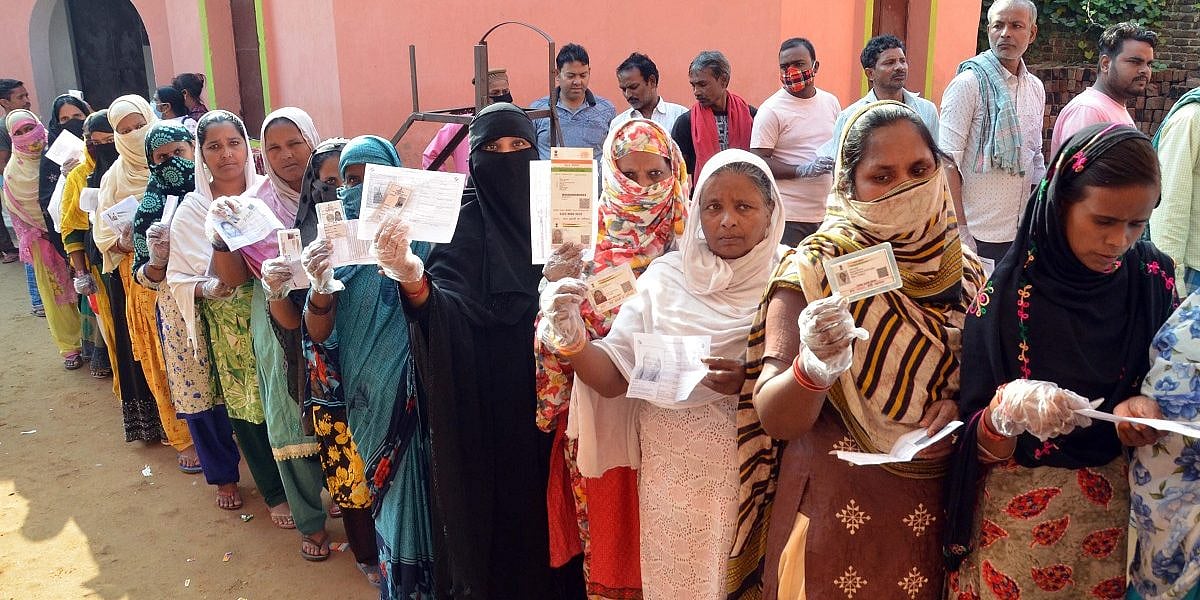 PTI : Voters show their identity cards before casting their respective votes at a polling station, during Tarapur assembly by-polls, in Munger district, October 30, 2021.