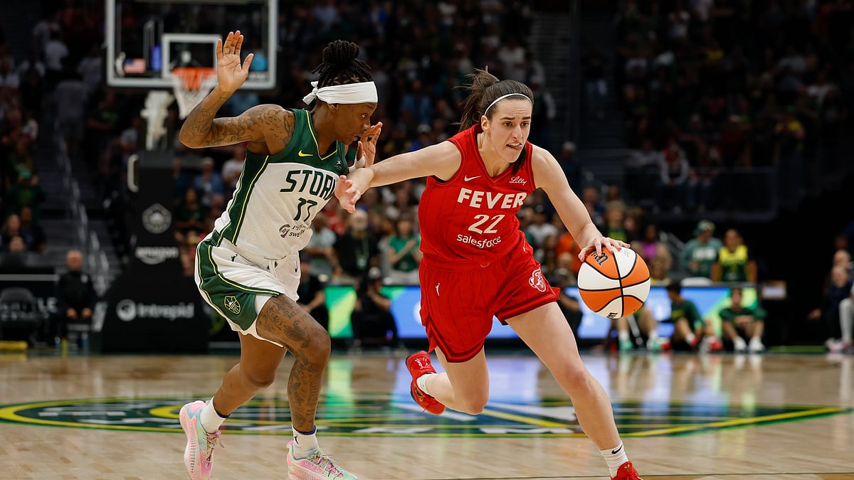 Caitlin Clark #22 of the Indiana Fever dribbles past Erica Wheeler #17 of the Seattle Storm during the third quarter at Climate Pledge Arena on June 24, 2025 in Seattle, Washington. The Indiana Fever won 94-86. - null
