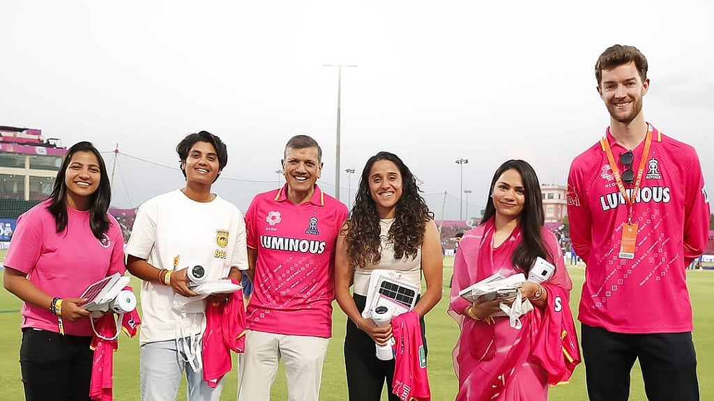 Photo: X | Rajasthan Royals : IPL franchise Rajasthan Royals owner Manoj Badale and CEO Jake Lush McCrum with India's sportswomen during an RR event.