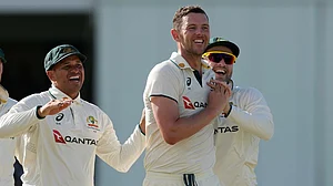 Photo: AP : Australia's Josh Hazlewood, centre, celebrates after taking the wicket of West Indies' Brandon King on day three of the first Test in Bridgetown, Barbados.
