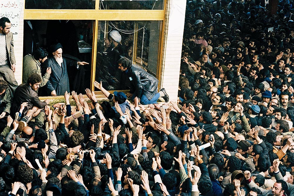 Photo: AP : Supreme Leader: People reach out to Ayatollah Ruhollah Khomeini in Tehran on February 4, 1979