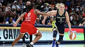 Paige Bueckers #5 of the Dallas Wings drives around Kelsey Mitchell #0 of the Indiana Fever during the second half of a game at American Airlines Center on June 27, 2025 in Dallas, Texas.