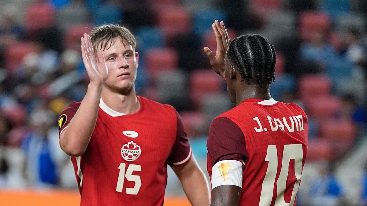 AP Photo/Ashley Landis : Canada forward Jonathan David (10) celebrates with defender Luc De Fougerolles (15) after scoring during a CONCACAF Gold Cup football match against El Salvador in Houston.