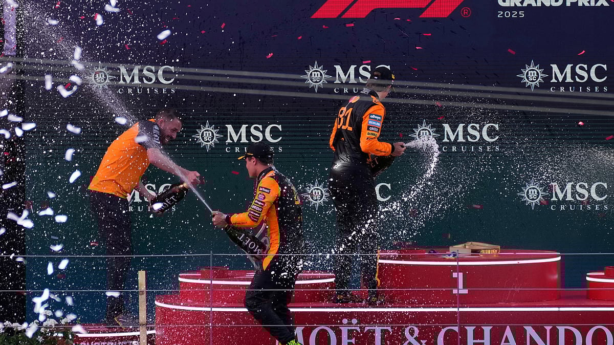 (AP Photo/Darko Bandic) : First-placed McLaren driver Lando Norris of Britain, left, and second-placed McLaren driver Oscar Piastri of Australia celebrate during the Austrian Formula One Grand Prix in Spielberg, Austria, Sunday, June 29, 2025. 
