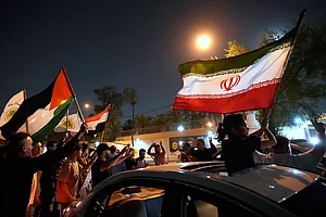 Photo: AP : Protesters gather in front of the Iranian Embassy