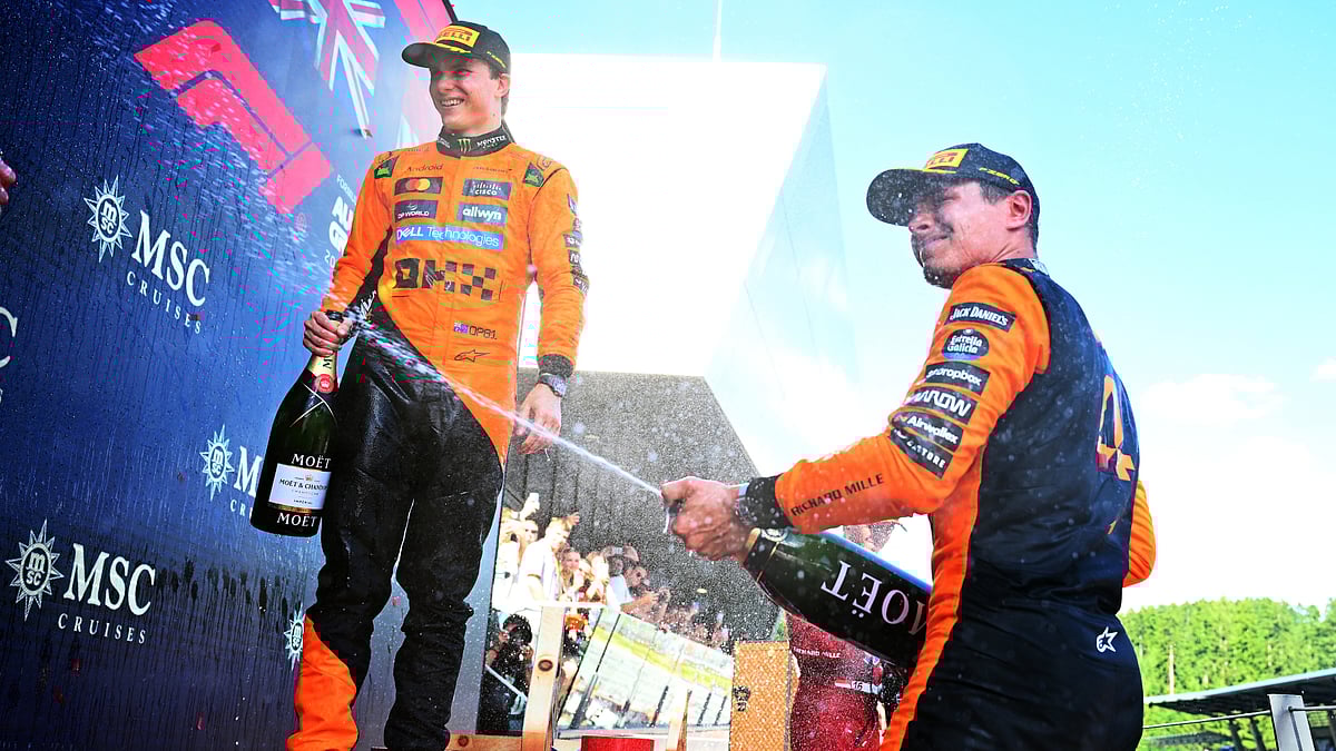 Oscar Piastri and Lando Norris celebrate after McLaren's latest one-two in Austria