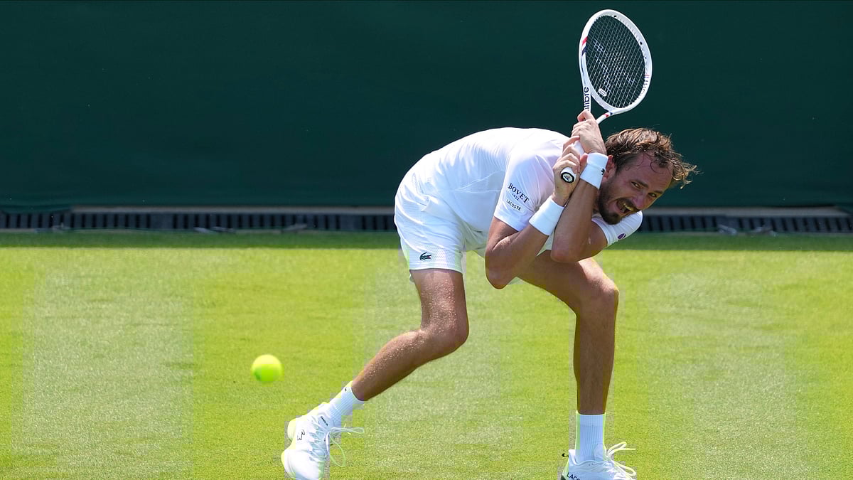 (AP Photo/Kirsty Wigglesworth) : Daniil Medvedev of Russia returns the ball to Benjamin Bonzi of France during their first round men's single match at the Wimbledon Tennis Championships in London, Monday, June 30, 2025. 