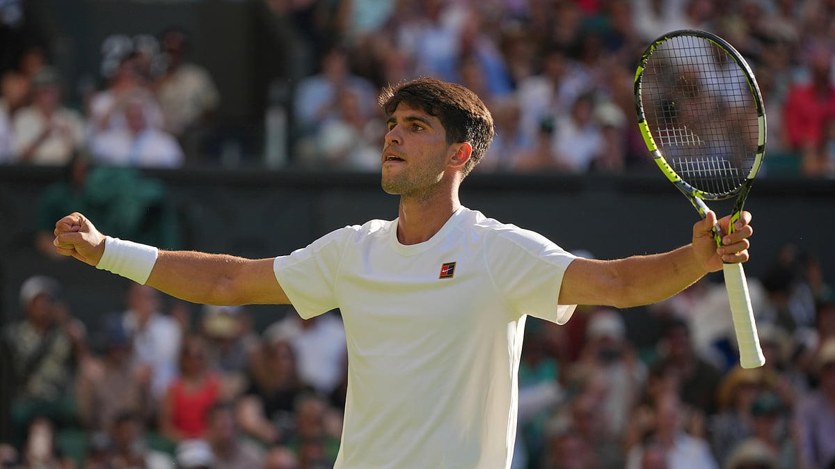 (AP Photo/Alastair Grant) : Carlos Alcaraz of Spain celebrates after beating Fabio Fognini of Italy during their first round men's singles match at the Wimbledon Tennis Championships in London, Monday, June 30, 2025. 