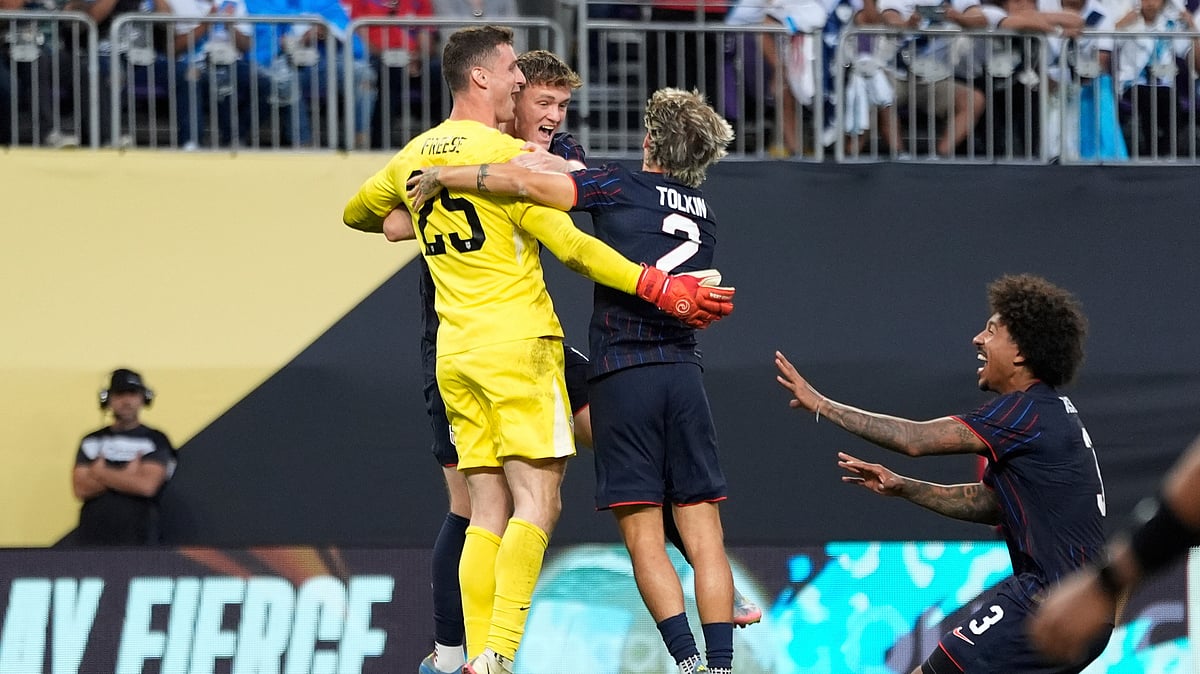 AP Photo/Abbie Parr : United States goalkeeper Matthew Freese celebrates with teammates after winning a penalty kick shootout of a CONCACAF Gold Cup quarterfinals football match against Costa Rica in Minneapolis.