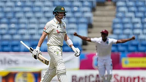 AP Photo/Ricardo Mazalan : Australia's Steve Smith walks off the field after being caught by West Indies' Anderson Phillip during day one of the second cricket Test match at National Cricket Stadium in St. George's, Grenada.