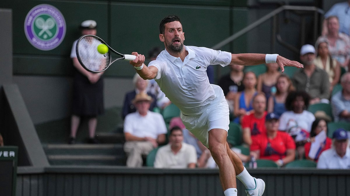 AP Photo/Kin Cheung : Novak Djokovic of Serbia returns to Alexandre Muller of France during their first round men's singles match at the Wimbledon Tennis Championships in London, Tuesday.