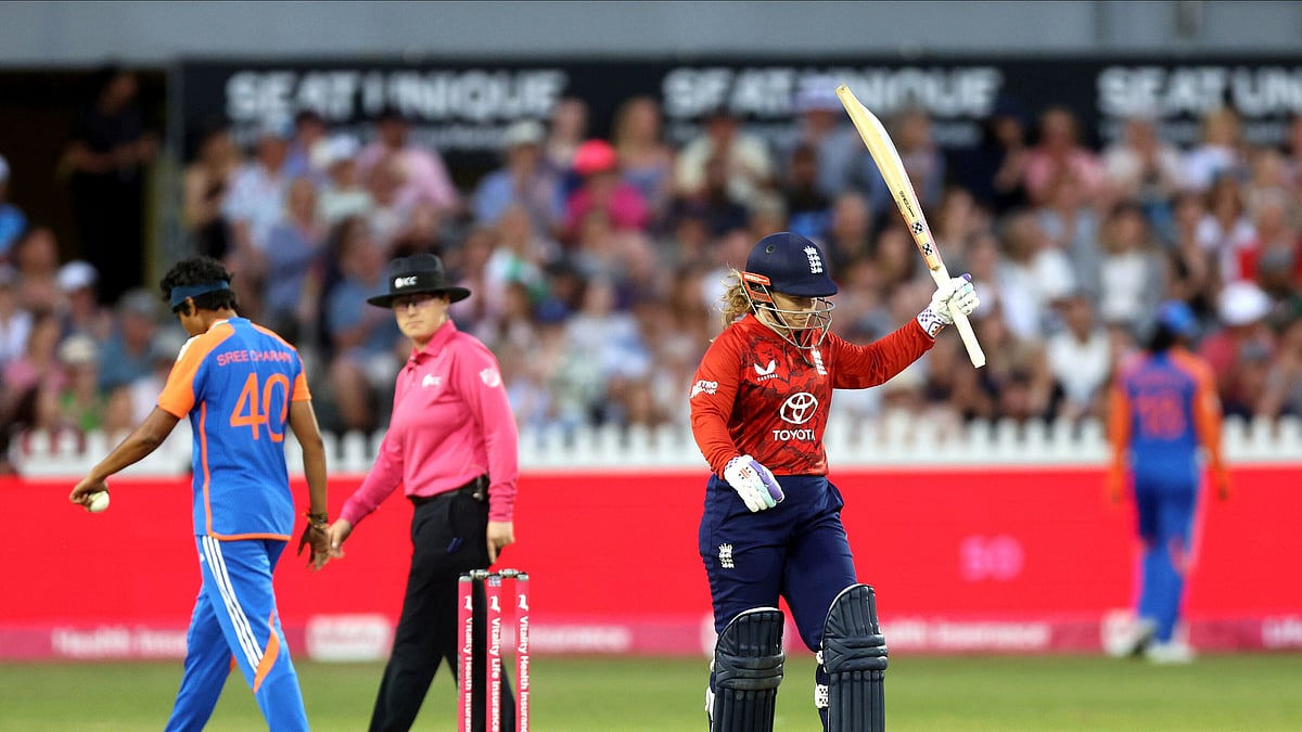 Nigel French/PA via AP : England's Tammy Beaumont celebrates making fifty runs during the second Women's International T20 Match between England and India at the Seat Unique Stadium, Bristol.