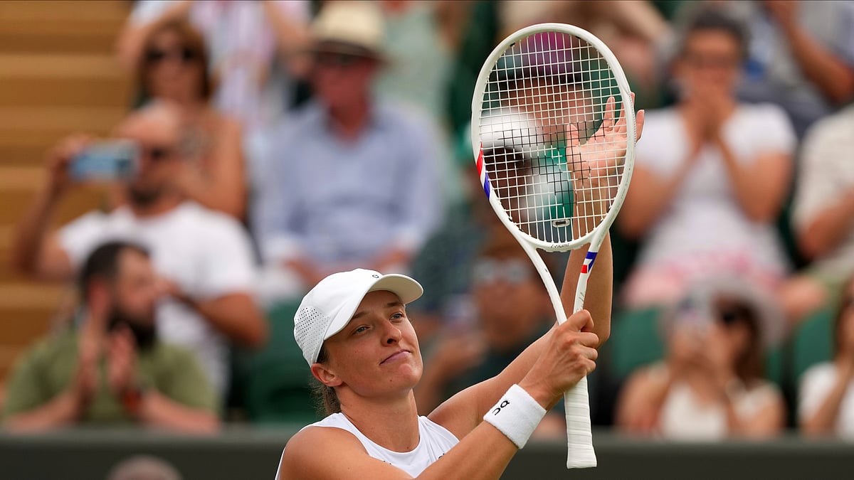 AP Photo/Joanna Chan : Iga Swiatek of Poland celebrates winning her first round women's single match against Polina Kudermetova of Russia at the Wimbledon Tennis Championships in London.
