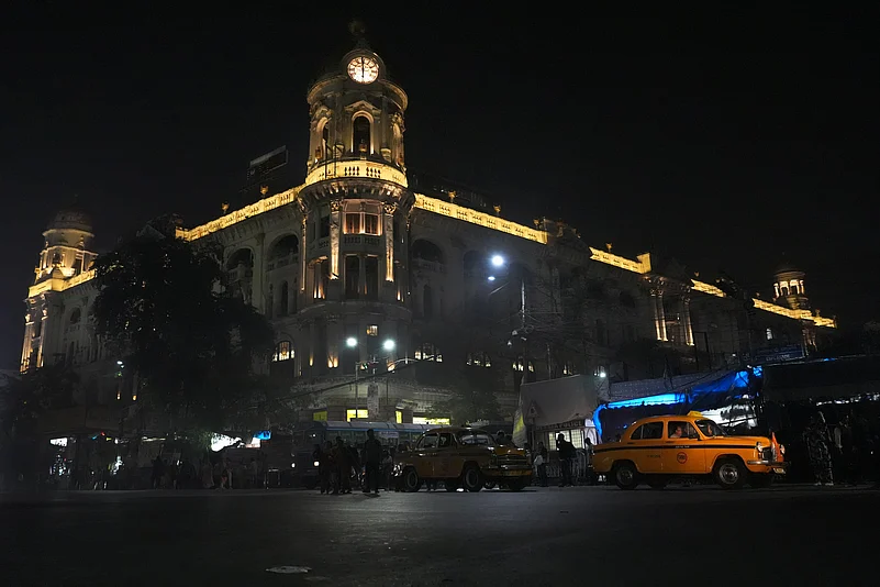 Yellow taxi at Chowringhee on the backdrop of Kolkatas heritage building Cottage Emporium/ OldLIC building.