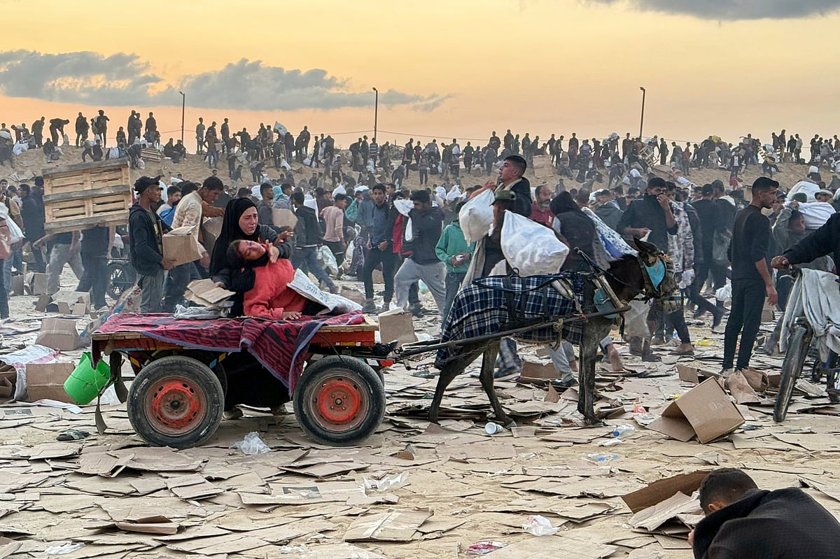 AP : This photo, provided by an American contractor on condition of anonymity because they were revealing their employers’ internal operations, shows a woman slumped over in a donkey cart after the contractor said she was hit in the head with part of a stun grenade at a food distribution site in Gaza run by the Gaza Humanitarian Foundation in June 2025. 