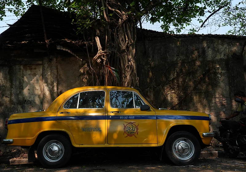 A yellow taxi on a Kolkata street.