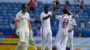 AP Photo/Ricardo Mazalan : West Indies' Jayden Seales celebrates after bowling Australia's Sam Konstas for a duck on day two of the second cricket Test match at the National Cricket Stadium in St. George's, Grenada.