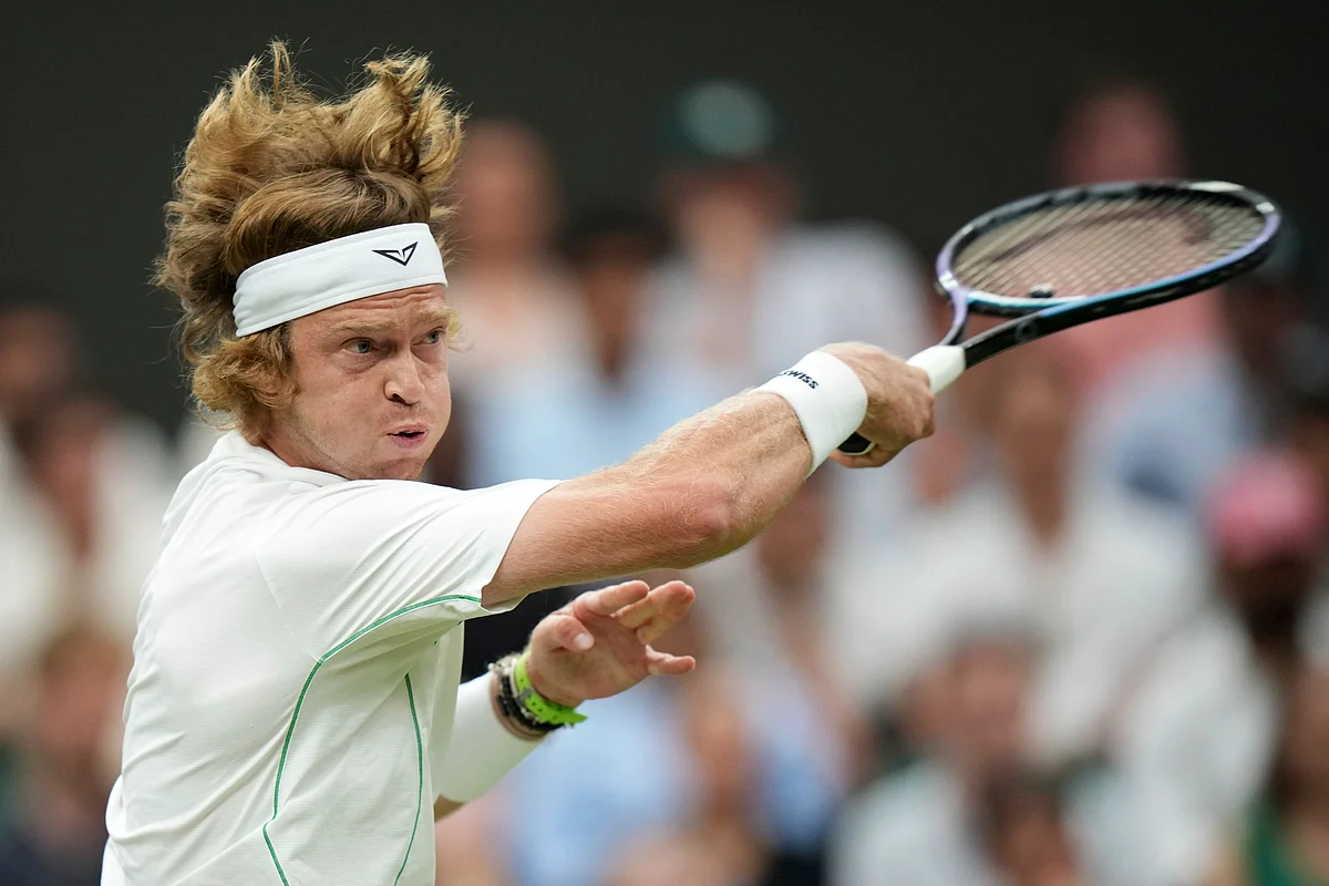 Russia's Andrey Rublev returns to Spain's Carlos Alcaraz during a fourth round men's singles match at the Wimbledon Tennis Championships in London, Sunday, July 6, 2025. 