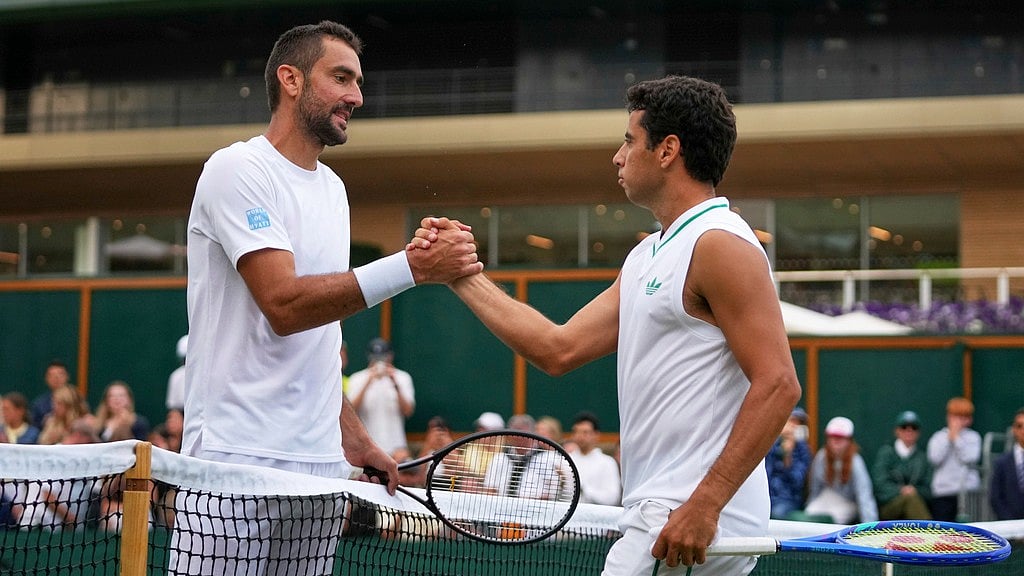 AP/Joanna Chan : Marin Cilic of Croatia, left, greets Jaume Munar of Spain at the net after winning a third round men's singles match at the Wimbledon Tennis Championships in London, Saturday, July 5, 2025.
