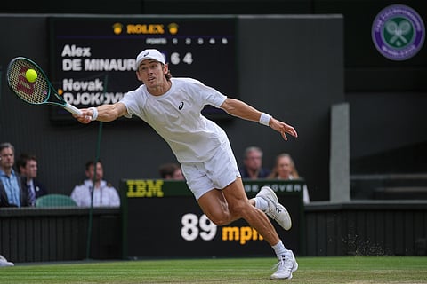 Australia's Alex de Minaur returns to Serbia's Novak Djokovic during a fourth round men's singles match at the Wimbledon Tennis Championships in London, Monday, July 7, 2025. 