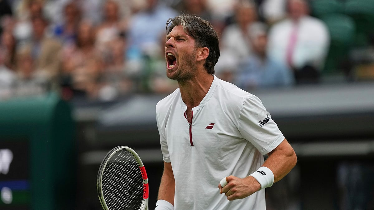AP Photo/Joanna Chan : Cameron Norrie of Britain reacts during his men's singles fourth round match against Nicolas Jarry of Chile at the Wimbledon Tennis Championships in London.
