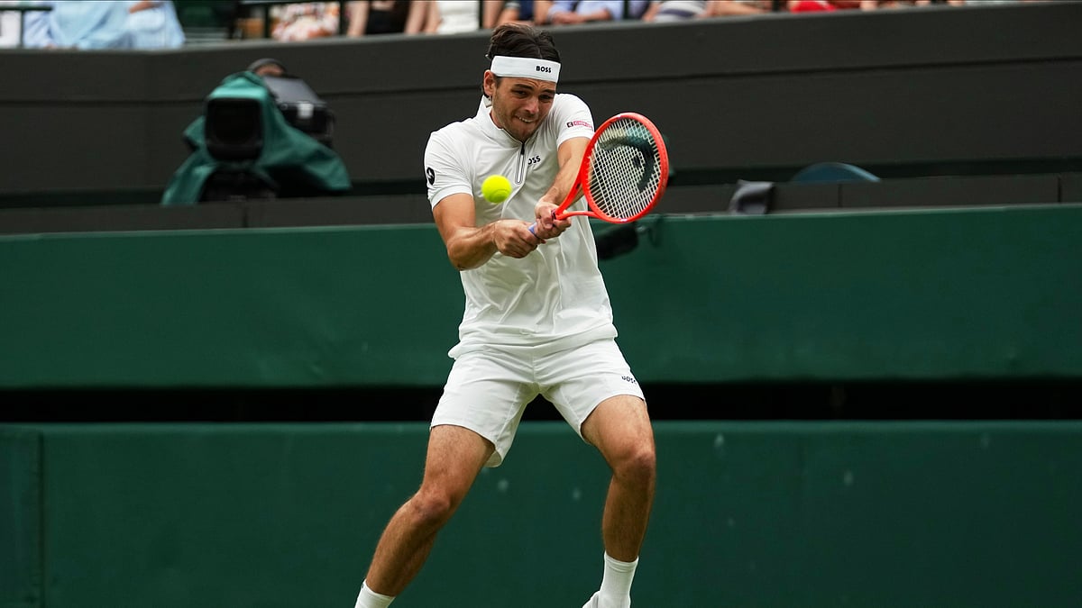 AP Photo/Joanna Chan : Taylor Fritz of the U.S. plays a return to Jordan Thompson of Australia during their men's singles fourth round match at the Wimbledon Tennis Championships in London.