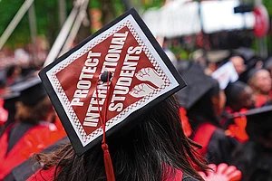 | Photo: Getty Images : Tense Atmosphere: Students of Harvard University hold a protest against the deportation of
international students during their graduation ceremony on May 29, 2025
