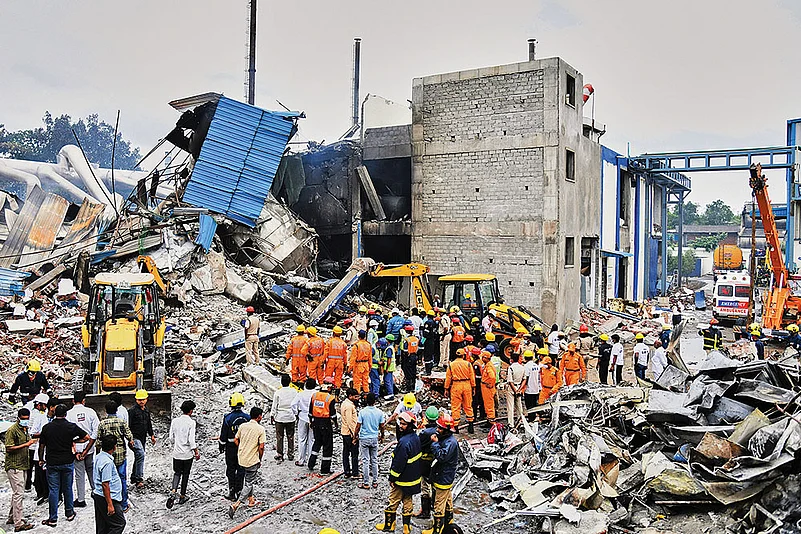The Day After: Rescue workers look for survivors at the explosion site
