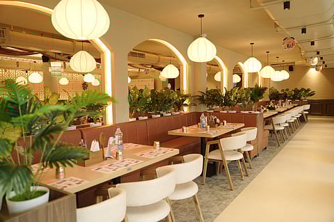 Modern restaurant interior with warm lighting and well-appointed tables.