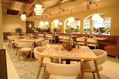 Modern restaurant interior with warm lighting and well-appointed tables.